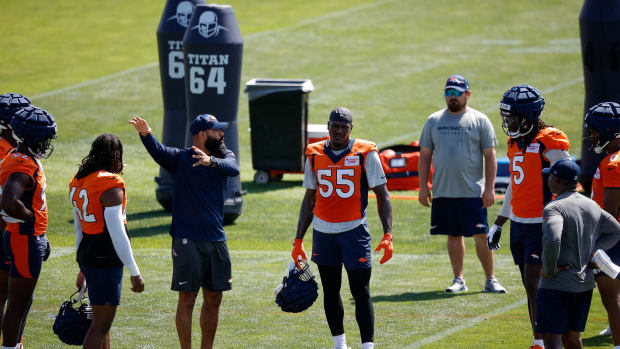 Denver Broncos outside linebackers coach Michael Wilhoite talks with linebacker Nik Bonitto (42) and linebacker Frank Clark (55) and linebacker Randy Gregory (5) during training camp at Centura Health Training Center.